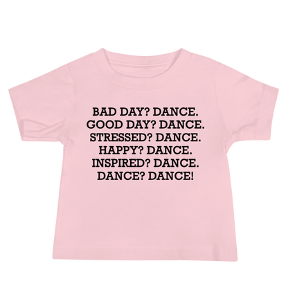 "Bad Day? Dance. Good Day? Dance. Stressed? Dance. Happy? Dance. Inspired? Dance. Dance? Dance!" printed on a pink baby jersey short sleeve tee laying on a flat surface