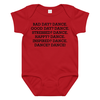 "Bad Day? Dance. Good Day? Dance. Stressed? Dance. Happy? Dance. Inspired? Dance. Dance? Dance!" printed on a red baby jersey bodysuit laying on a flat surface amongst other clothes