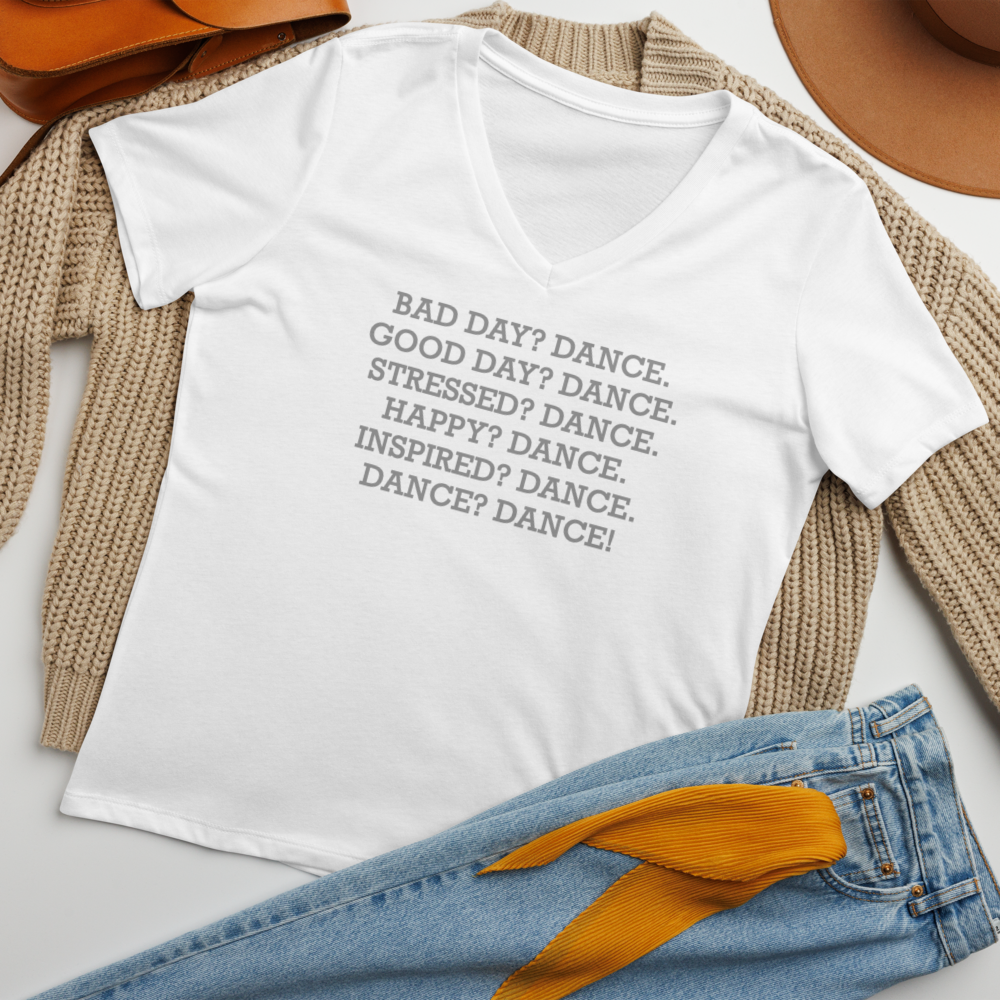 "Bad Day? Dance. Good Day? Dance. Stressed? Dance. Happy? Dance. Inspired? Dance. Dance? Dance!" printed on a solid white blend women's relaxed v-neck t-shirt laying on a flat surface amongst other clothes