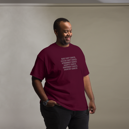 "Bad Day? Dance. Good Day? Dance. Stressed? Dance. Happy? Dance. Inspired? Dance. Dance? Dance!" printed on a maroon unisex classic tee worn by a male