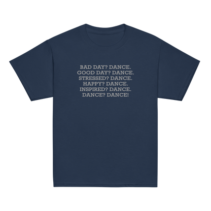 "Bad Day? Dance. Good Day? Dance. Stressed? Dance. Happy? Dance. Inspired? Dance. Dance? Dance!" printed on a navy youth classic tee laying on a flat surface