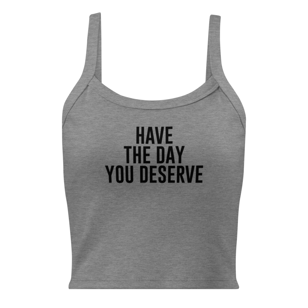 "Have the day you deserve" printed on a athletic heather women's micro-rib tanktop laying on a flat surface