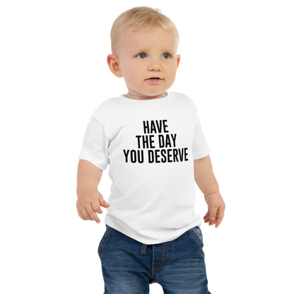 "Have the day you deserve" printed on a white baby jersey short sleeve tee worn by a male