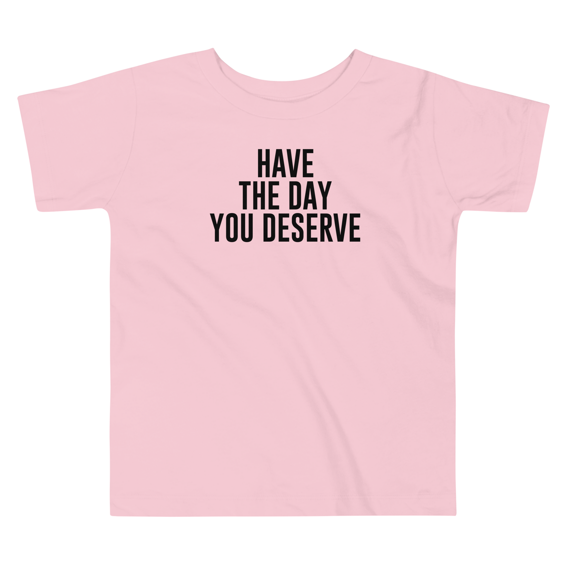 "Have the day you deserve" printed on a pink toddler short sleeve tee laying on a flat surface