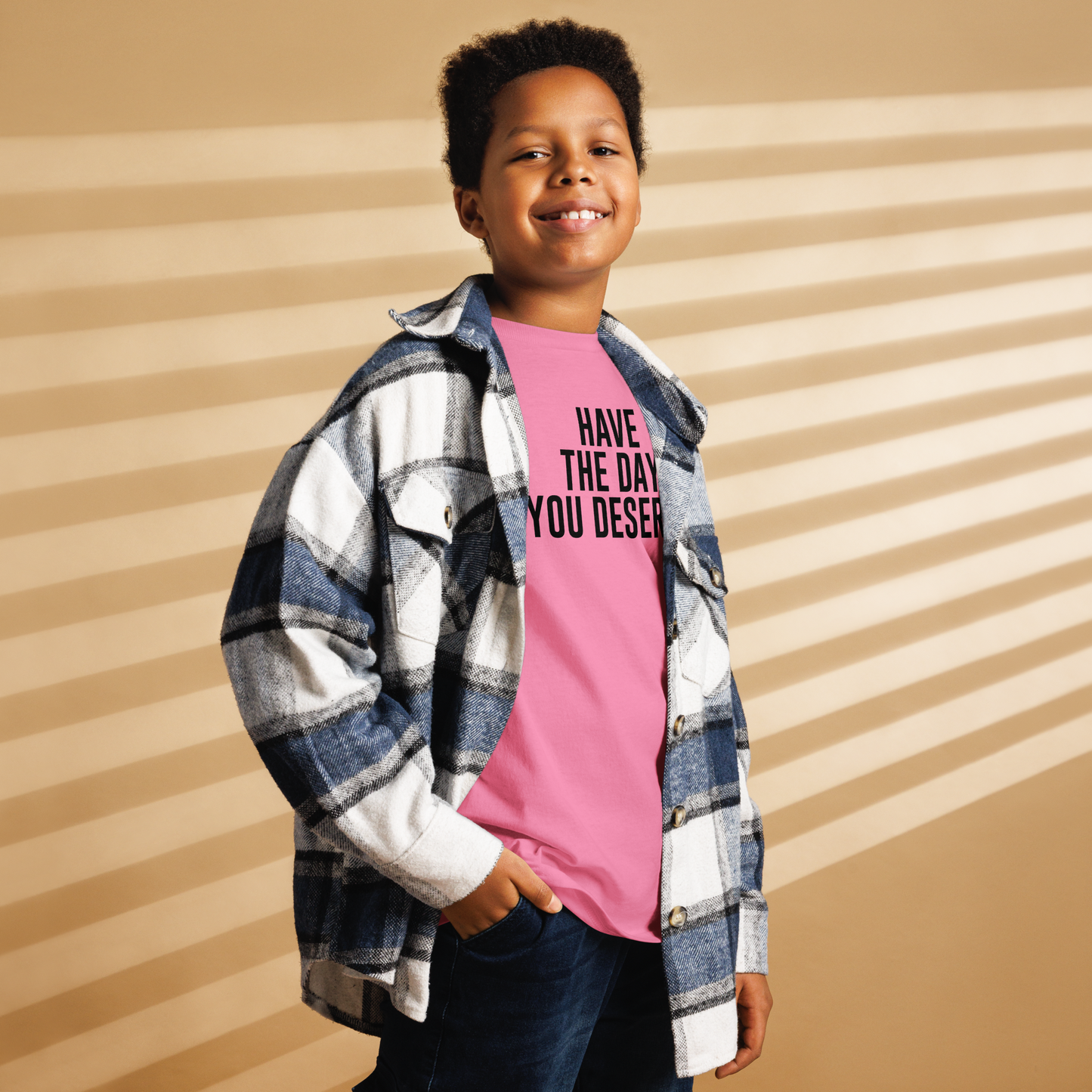 "Have the day you deserve" printed on a azalea youth classic tee worn by a male also wearing a jacket