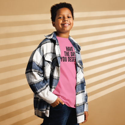 "Have the day you deserve" printed on a azalea youth classic tee worn by a male also wearing a jacket
