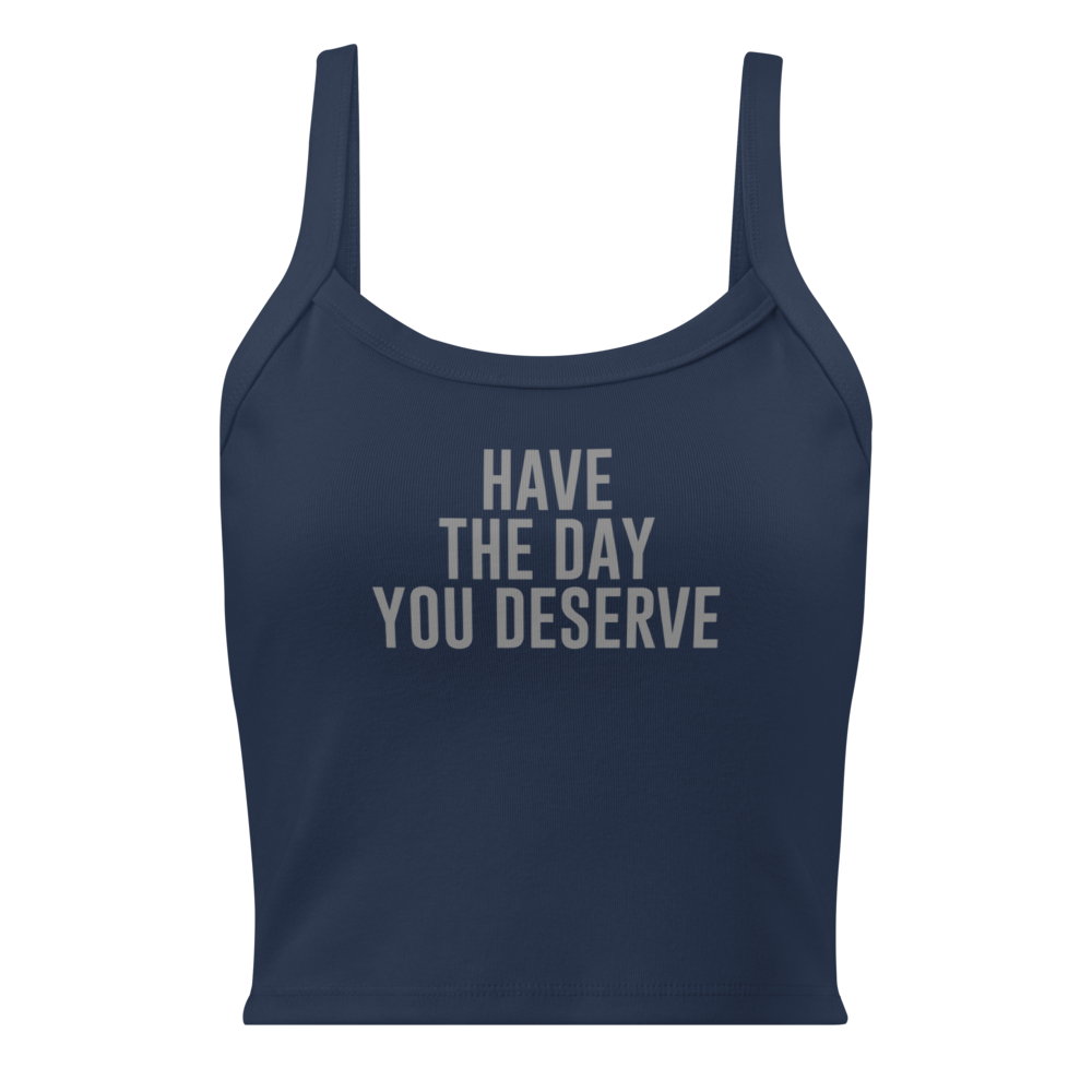 "Have the day you deserve" printed on a solid navy blend women's micro-rib tanktop laying on a flat surface