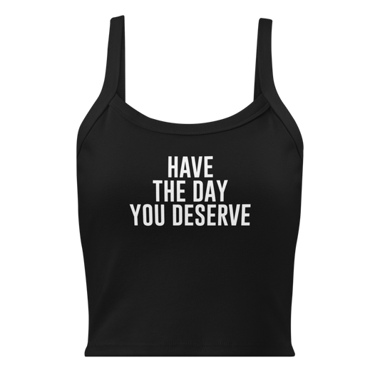 "Have the day you deserve" printed on a solid black blend women's micro-rib tanktop laying on a flat surface