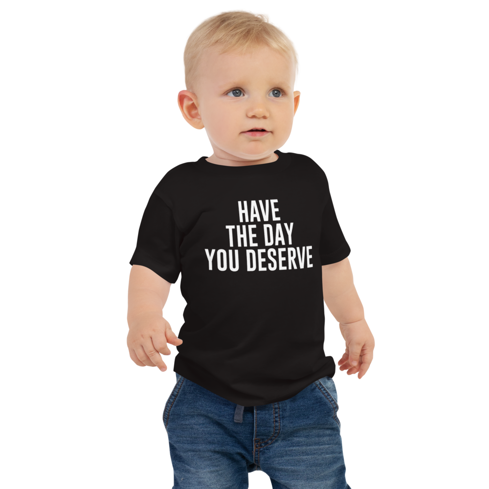 "Have the day you deserve" printed on a black baby jersey short sleeve tee worn by a male