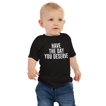 "Have the day you deserve" printed on a black baby jersey short sleeve tee worn by a male