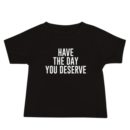 "Have the day you deserve" printed on a black baby jersey short sleeve tee laying on a flat surface
