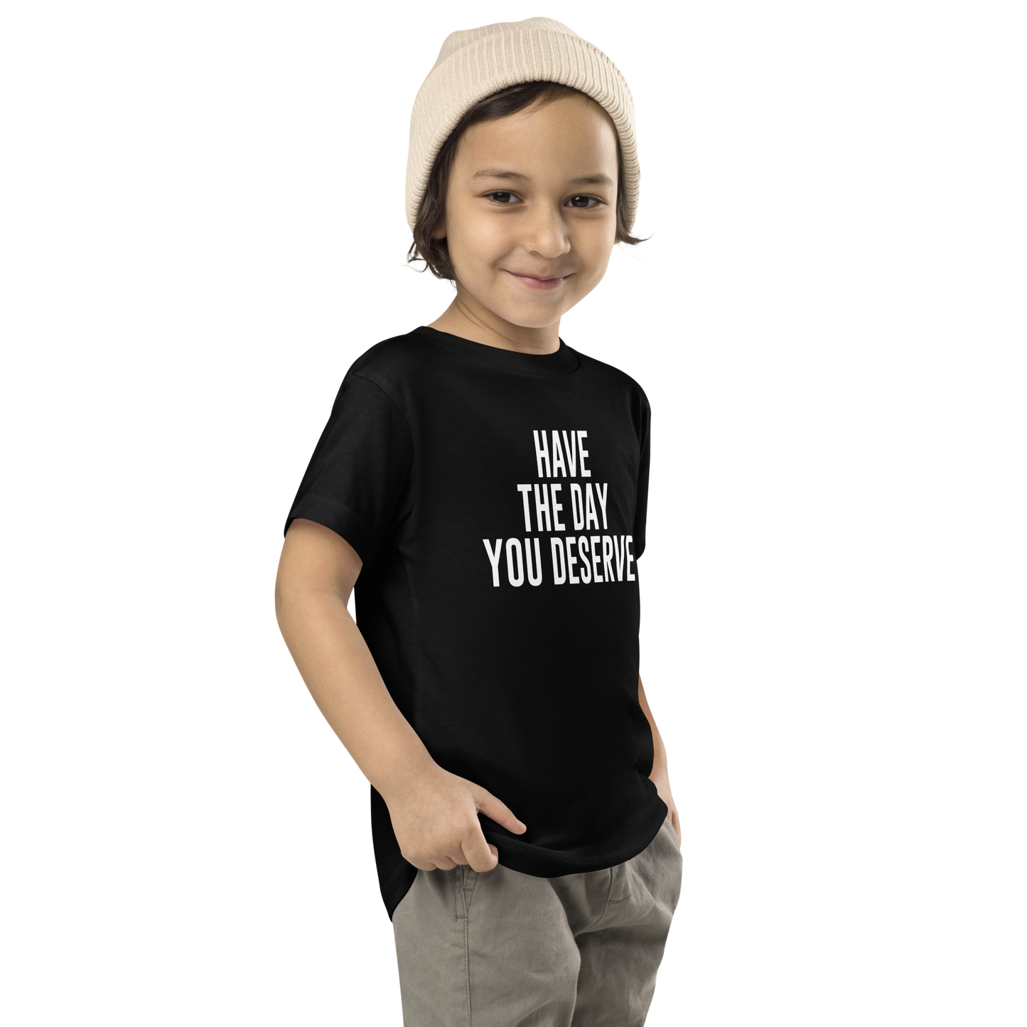 "Have the day you deserve" printed on a black toddler short sleeve tee worn by a male who is also wearing a knit cap