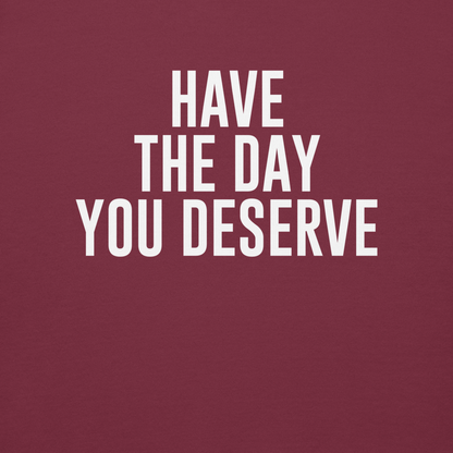 "Have the day you deserve" printed on a maroon background