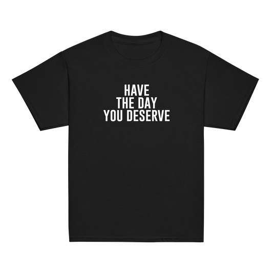 "Have the day you deserve" printed on a black youth classic tee laying on a flat surface