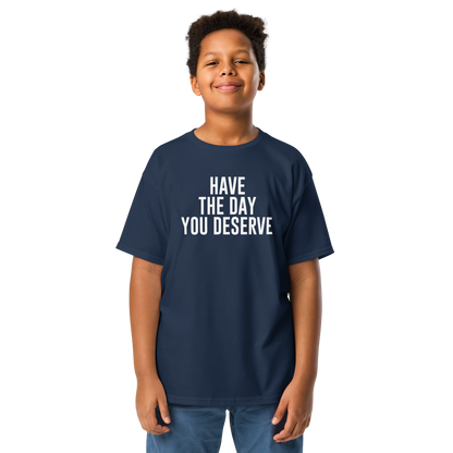 "Have the day you deserve" printed on a navy youth classic tee worn by a male
