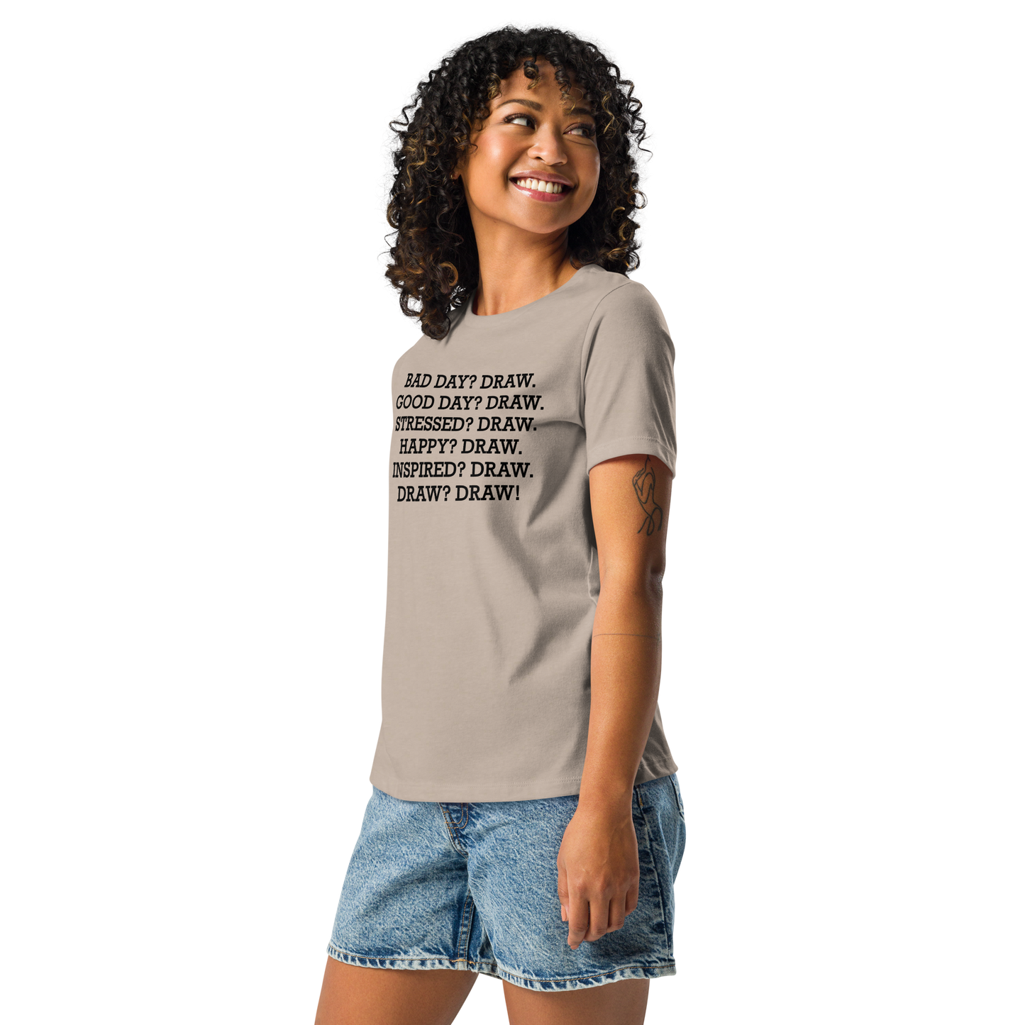 "Bad Day? Draw. Good Day? Draw. Stressed? Draw. Happy? Draw. Inspired? Draw. Draw? Draw!" printed on a heather stone women's relaxed t-shirt worn by a female