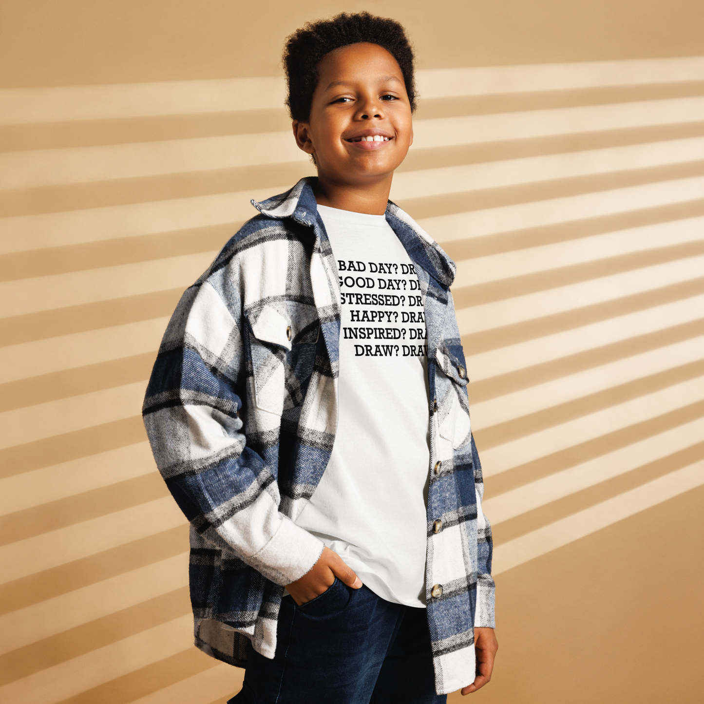 "Bad Day? Draw. Good Day? Draw. Stressed? Draw. Happy? Draw. Inspired? Draw. Draw? Draw!" printed on a white youth classic tee worn by a male also wearing a jacket