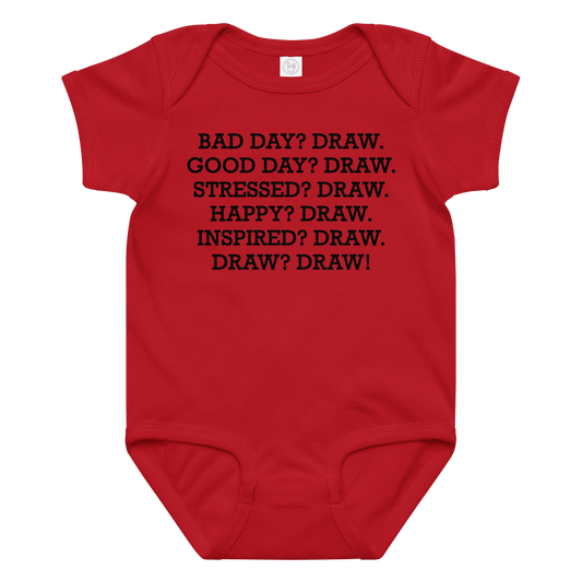 "Bad Day? Draw. Good Day? Draw. Stressed? Draw. Happy? Draw. Inspired? Draw. Draw? Draw!" printed on a red baby jersey bodysuit laying on a flat surface amongst other clothes