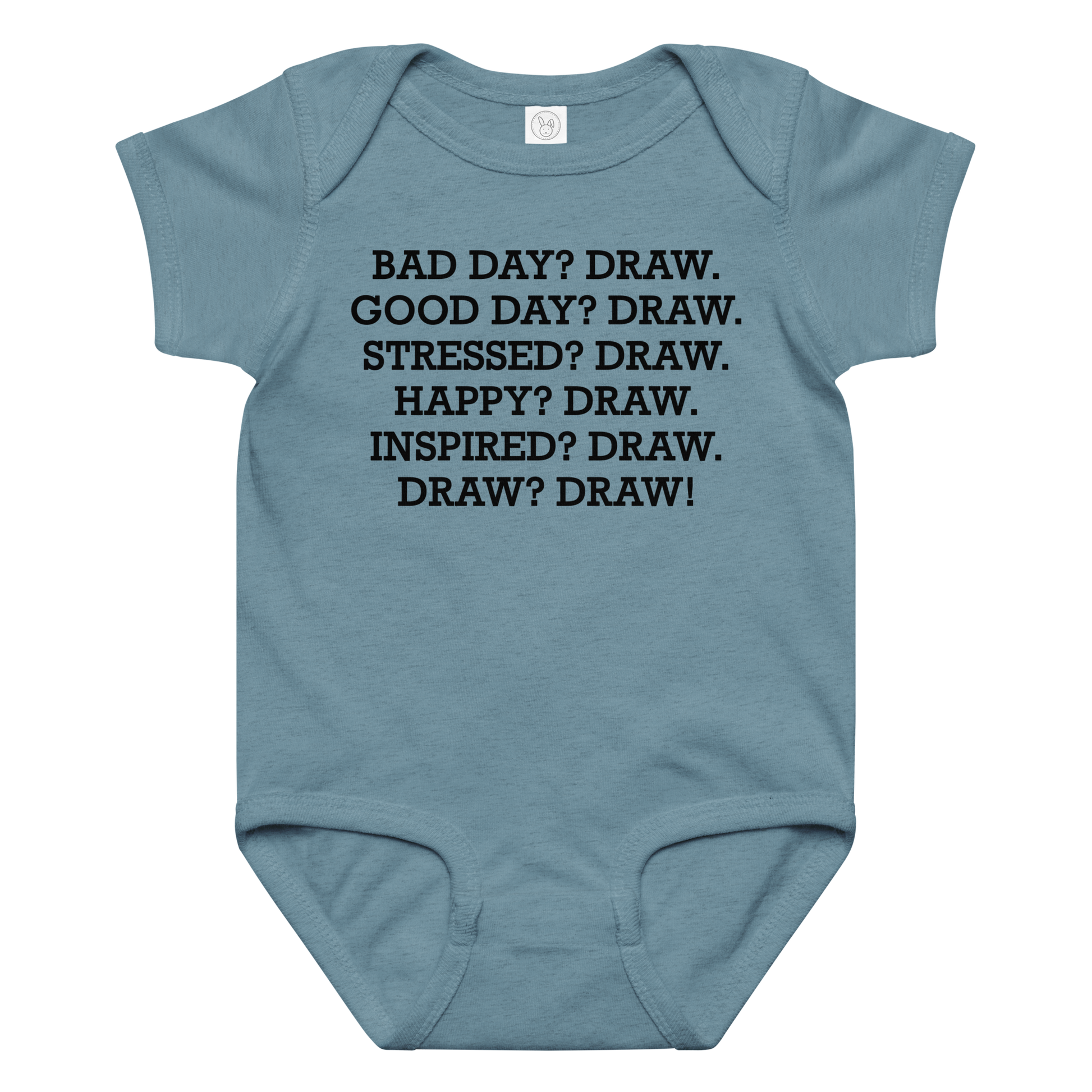 "Bad Day? Draw. Good Day? Draw. Stressed? Draw. Happy? Draw. Inspired? Draw. Draw? Draw!" printed on a vintage indigo baby jersey bodysuit laying on a flat surface amongst other clothes