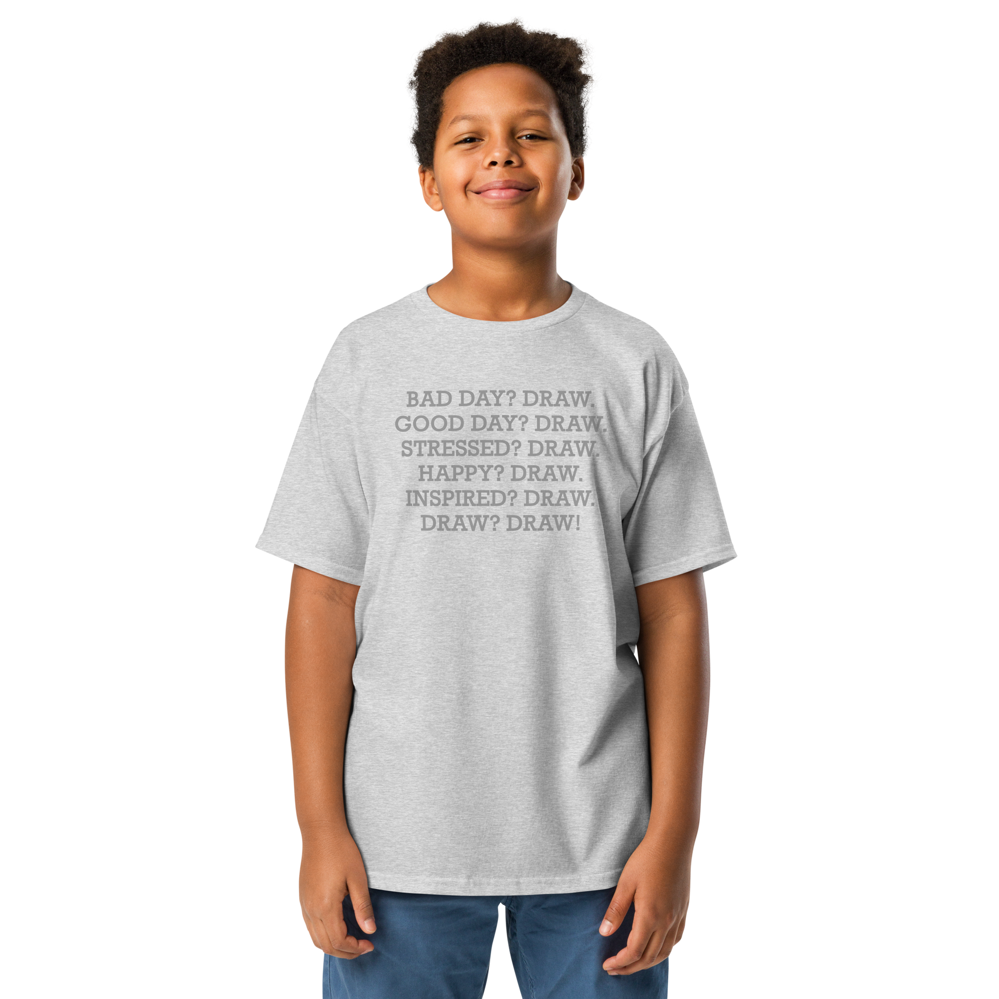 "Bad Day? Draw. Good Day? Draw. Stressed? Draw. Happy? Draw. Inspired? Draw. Draw? Draw!" printed on a sport grey youth classic tee worn by a male