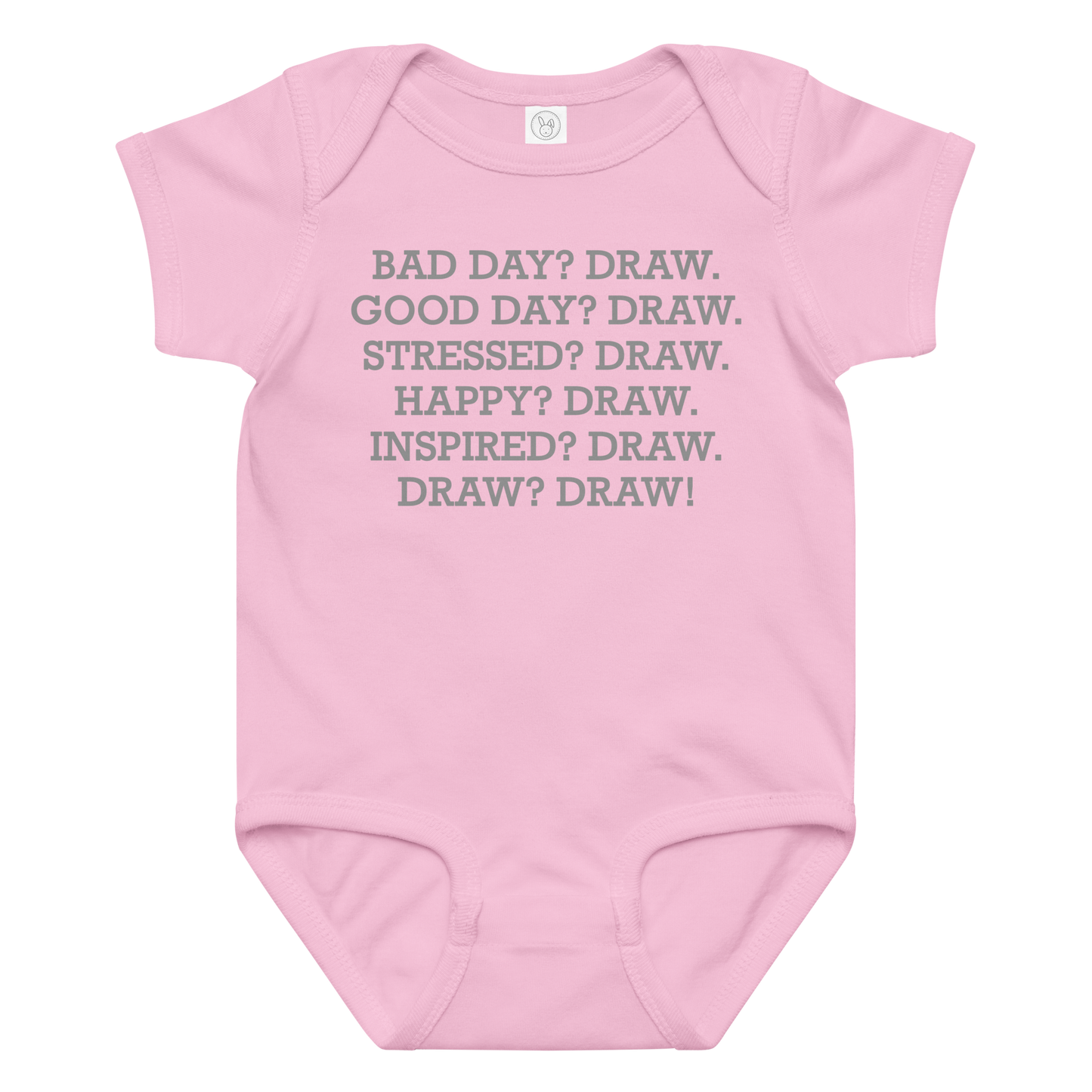 "Bad Day? Draw. Good Day? Draw. Stressed? Draw. Happy? Draw. Inspired? Draw. Draw? Draw!" printed on a pink baby jersey bodysuit laying on a flat surface amongst other clothes