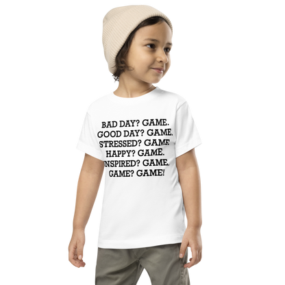 "Bad Day? Game. Good Day? Game. Stressed? Game. Happy? Game. Inspired? Game. Game? Game!" printed on a white toddler short sleeve tee worn by a male wearing a cap