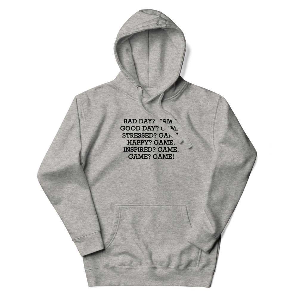 "Bad Day? Game. Good Day? Game. Stressed? Game. Happy? Game. Inspired? Game. Game? Game!" printed on a carbon grey unisex hoodie laying on a flat surface with the hood up