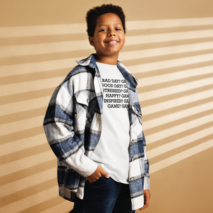 "Bad Day? Game. Good Day? Game. Stressed? Game. Happy? Game. Inspired? Game. Game? Game!" printed on a white youth classic tee worn by a male also wearing a jacket