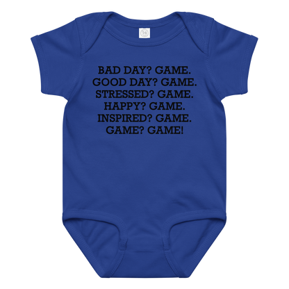"Bad Day? Game. Good Day? Game. Stressed? Game. Happy? Game. Inspired? Game. Game? Game!" printed on a royal baby jersey bodysuit laying on a flat surface amongst other clothes