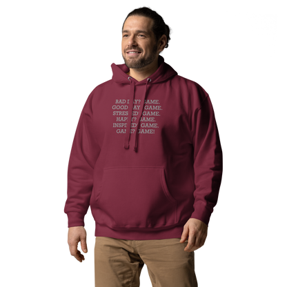 "Bad Day? Game. Good Day? Game. Stressed? Game. Happy? Game. Inspired? Game. Game? Game!" printed on a maroon unisex hoodie worn by a male