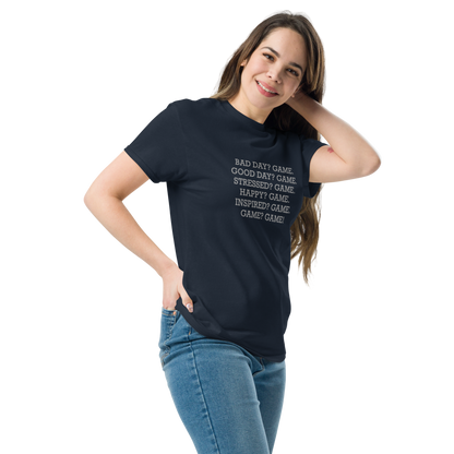"Bad Day? Game. Good Day? Game. Stressed? Game. Happy? Game. Inspired? Game. Game? Game!" printed on a navy unisex classic tee worn by a female