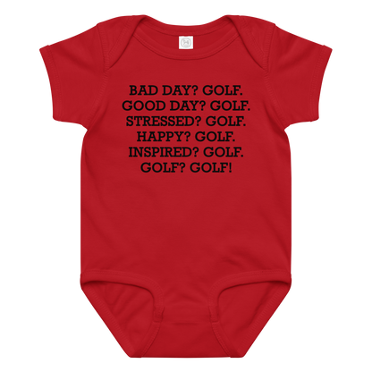 "Bad Day? Golf. Good Day? Golf. Stressed? Golf. Happy? Golf. Inspired? Golf. Golf? Golf!" printed on a red baby jersey bodysuit laying on a flat surface amongst other clothes