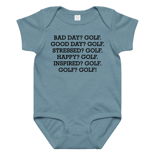"Bad Day? Golf. Good Day? Golf. Stressed? Golf. Happy? Golf. Inspired? Golf. Golf? Golf!" printed on a vintage indigo baby jersey bodysuit laying on a flat surface amongst other clothes