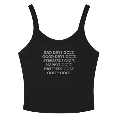 "Bad Day? Golf. Good Day? Golf. Stressed? Golf. Happy? Golf. Inspired? Golf. Golf? Golf!" printed on a solid black blend women's micro-rib tanktop laying on a flat surface amongst sunglasses and shorts