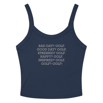 "Bad Day? Golf. Good Day? Golf. Stressed? Golf. Happy? Golf. Inspired? Golf. Golf? Golf!" printed on a solid navy blend women's micro-rib tanktop laying on a flat surface amongst sunglasses and shorts