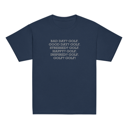 "Bad Day? Golf. Good Day? Golf. Stressed? Golf. Happy? Golf. Inspired? Golf. Golf? Golf!" printed on a navy youth classic tee laying on a flat surface