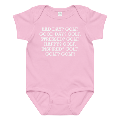 "Bad Day? Golf. Good Day? Golf. Stressed? Golf. Happy? Golf. Inspired? Golf. Golf? Golf!" printed on a pink baby jersey bodysuit laying on a flat surface amongst other clothes