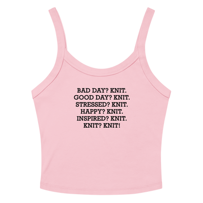"Bad Day? Knit. Good Day? Knit. Stressed? Knit. Happy? Knit. Inspired? Knit. Knit? Knit!" printed on a solid pink blend women's micro-rib tanktop laying on a flat surface amongst sunglasses and shorts