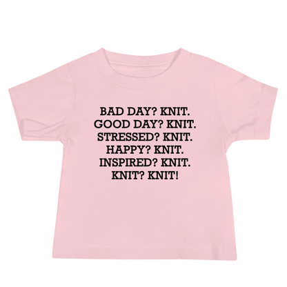 "Bad Day? Knit. Good Day? Knit. Stressed? Knit. Happy? Knit. Inspired? Knit. Knit? Knit!" printed on a pink baby jersey short sleeve tee laying on a flat surface