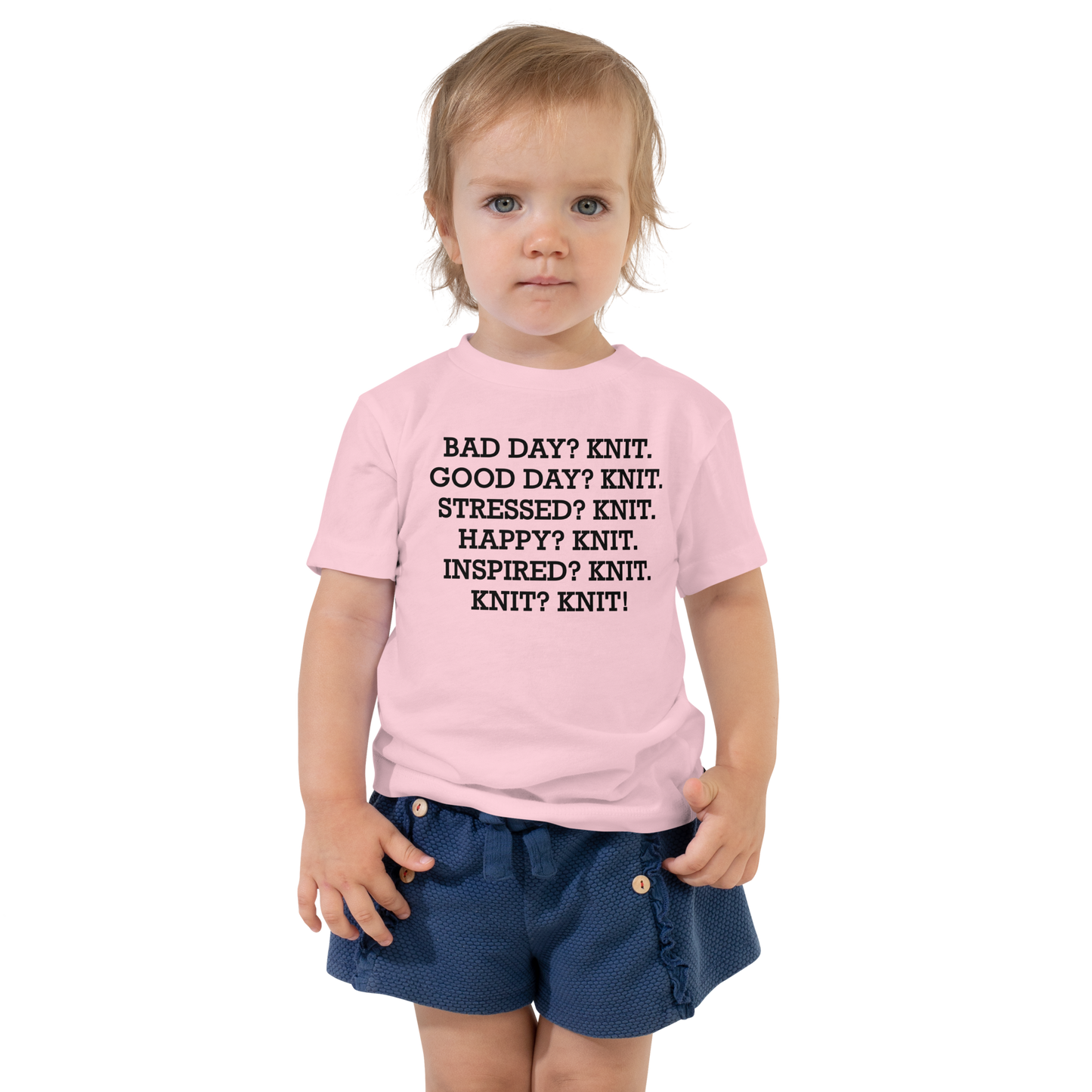 "Bad Day? Knit. Good Day? Knit. Stressed? Knit. Happy? Knit. Inspired? Knit. Knit? Knit!" printed on a pink toddler short sleeve tee worn by a female