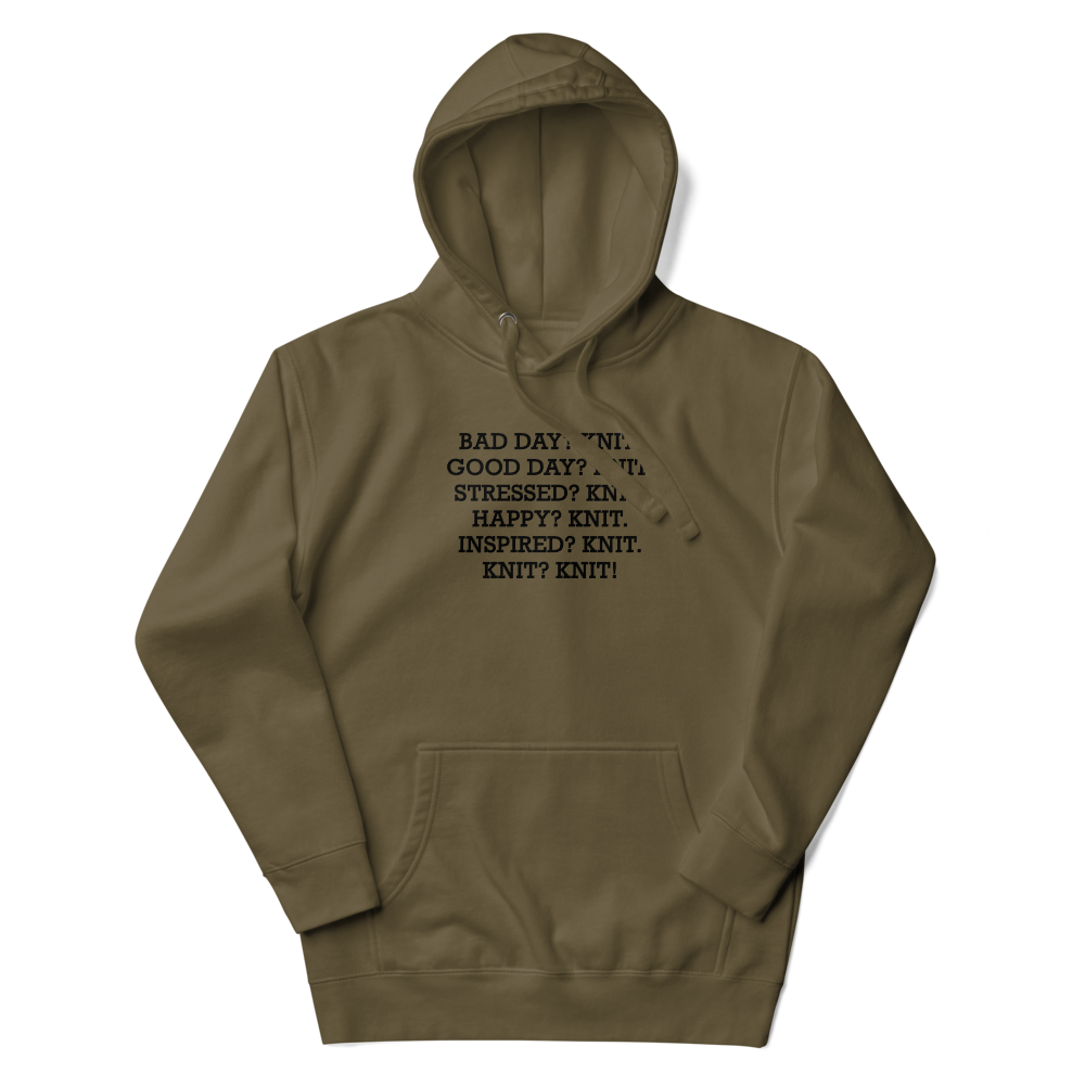 "Bad Day? Knit. Good Day? Knit. Stressed? Knit. Happy? Knit. Inspired? Knit. Knit? Knit!" printed on a military green unisex hoodie laying on a flat surface with the hood up