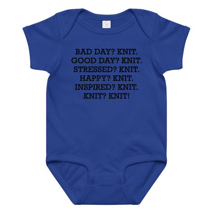 "Bad Day? Knit. Good Day? Knit. Stressed? Knit. Happy? Knit. Inspired? Knit. Knit? Knit!" printed on a royal baby jersey bodysuit laying on a flat surface amongst other clothes