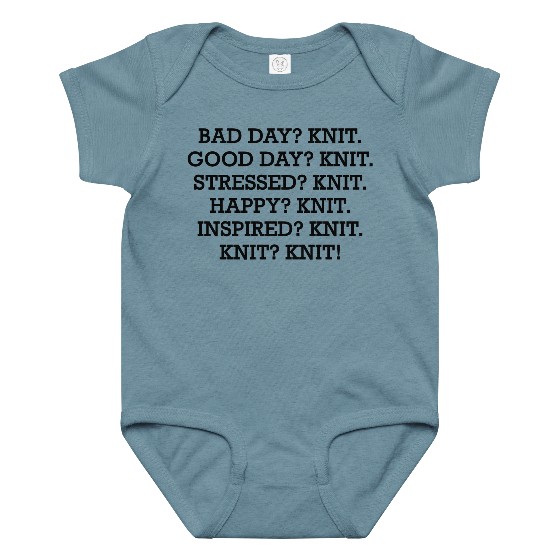 "Bad Day? Knit. Good Day? Knit. Stressed? Knit. Happy? Knit. Inspired? Knit. Knit? Knit!" printed on a vintage indigo baby jersey bodysuit laying on a flat surface amongst other clothes