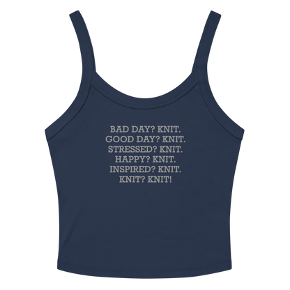 "Bad Day? Knit. Good Day? Knit. Stressed? Knit. Happy? Knit. Inspired? Knit. Knit? Knit!" printed on a solid navy blend women's micro-rib tanktop laying on a flat surface amongst sunglasses and shorts