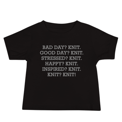 "Bad Day? Knit. Good Day? Knit. Stressed? Knit. Happy? Knit. Inspired? Knit. Knit? Knit!" printed on a black baby jersey short sleeve tee laying on a flat surface