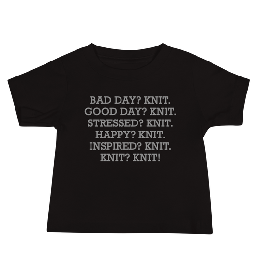 "Bad Day? Knit. Good Day? Knit. Stressed? Knit. Happy? Knit. Inspired? Knit. Knit? Knit!" printed on a black baby jersey short sleeve tee laying on a flat surface