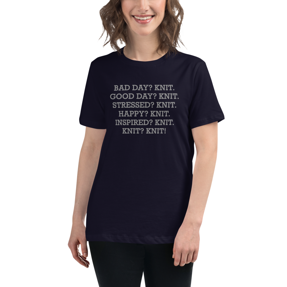 "Bad Day? Knit. Good Day? Knit. Stressed? Knit. Happy? Knit. Inspired? Knit. Knit? Knit!" printed on a navy women's relaxed t-shirt worn by a female
