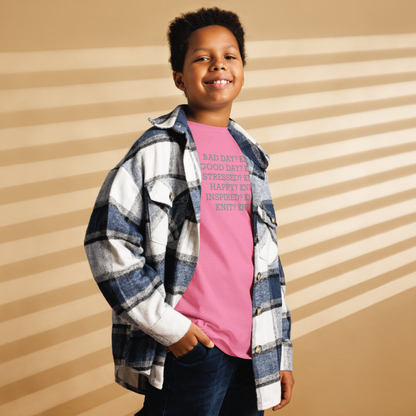 "Bad Day? Knit. Good Day? Knit. Stressed? Knit. Happy? Knit. Inspired? Knit. Knit? Knit!" printed on a azalea youth classic tee worn by a male also wearing a jacket