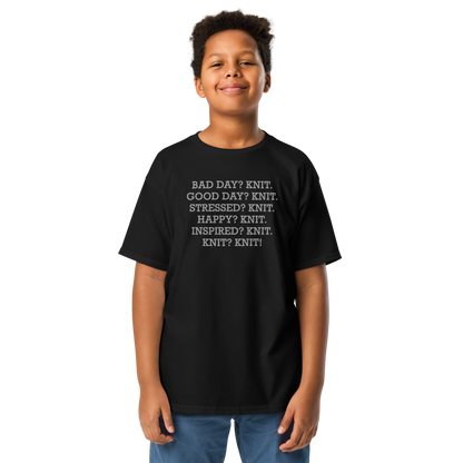 "Bad Day? Knit. Good Day? Knit. Stressed? Knit. Happy? Knit. Inspired? Knit. Knit? Knit!" printed on a black youth classic tee worn by a male
