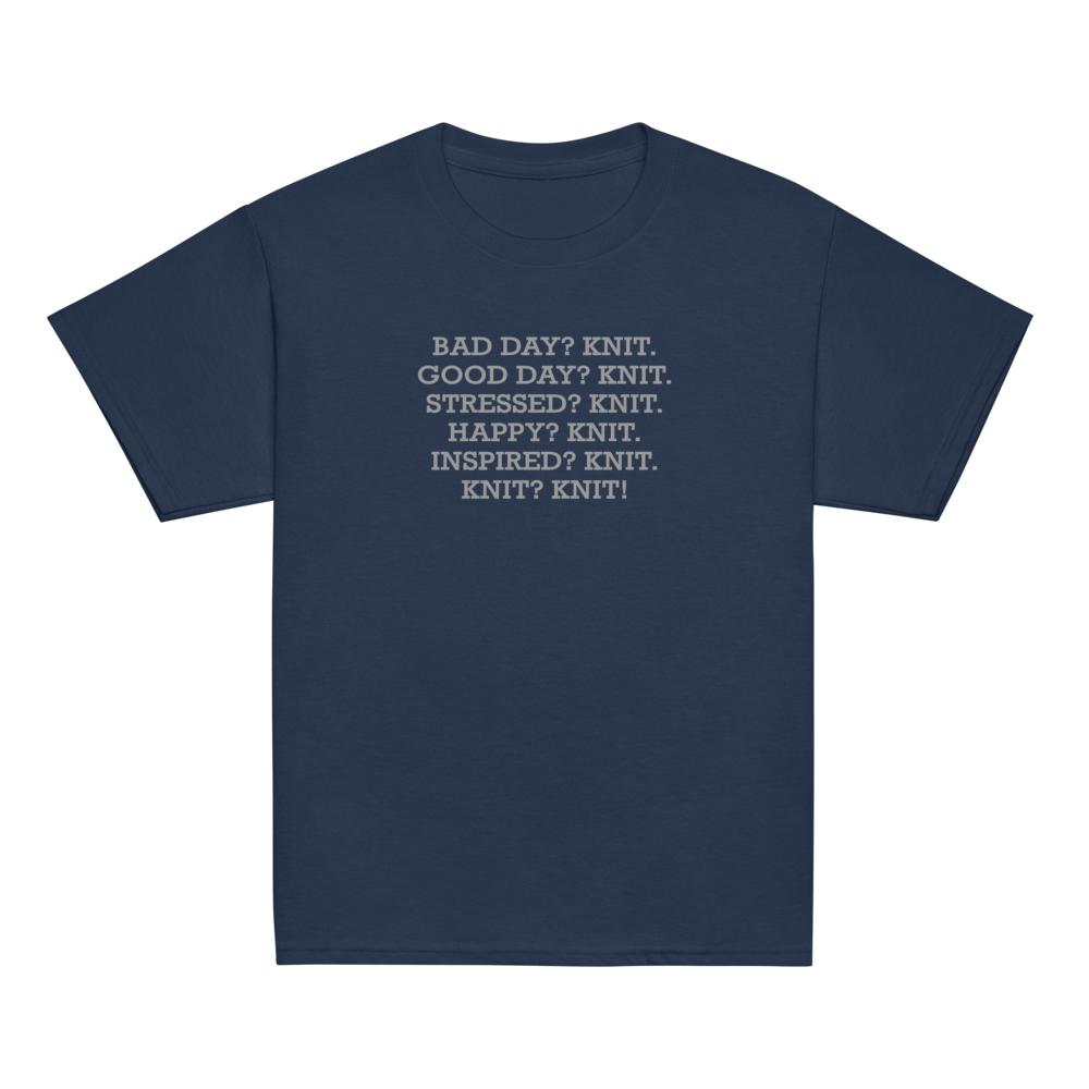 "Bad Day? Knit. Good Day? Knit. Stressed? Knit. Happy? Knit. Inspired? Knit. Knit? Knit!" printed on a navy youth classic tee laying on a flat surface